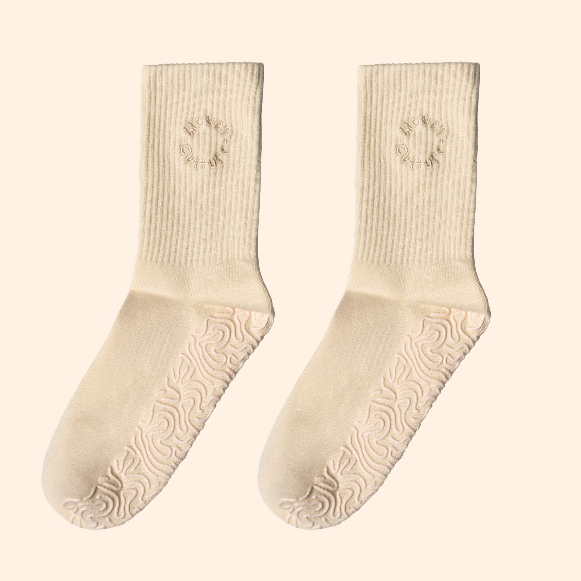 Cream organic cotton grip socks with non-slip sole and Woven Culture logo, sustainable yoga and Pilates socks.